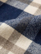 Close-up of comfy flannel classic plaid fabric in blue, beige, and cream colors