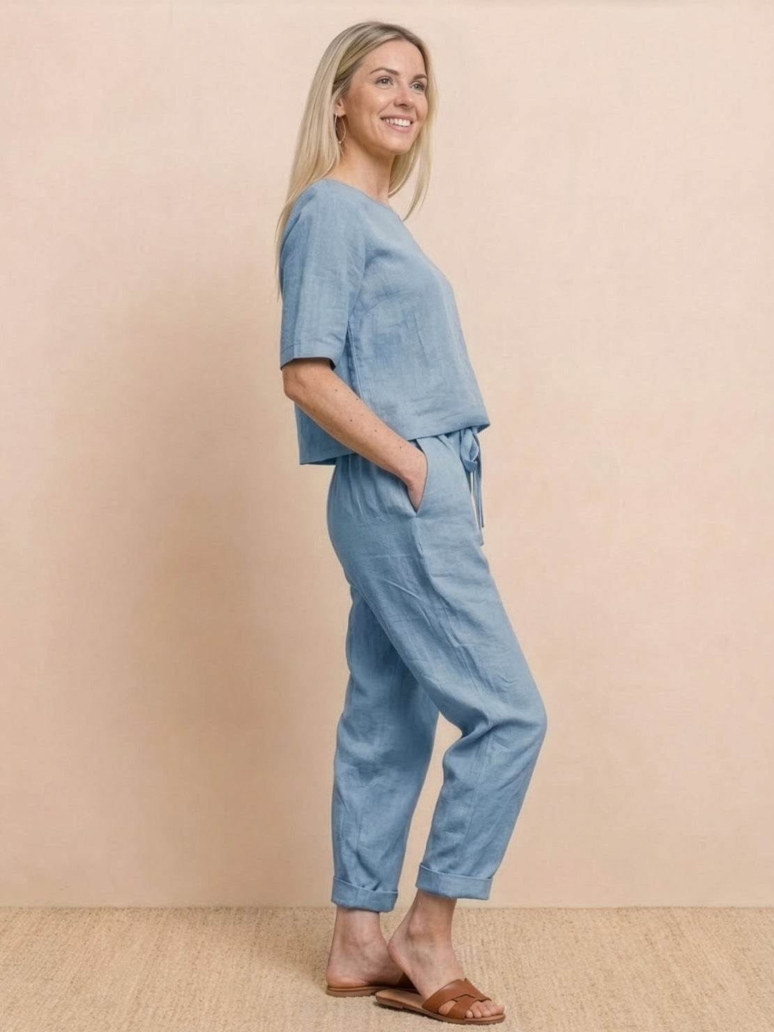 Woman wearing a breathable cotton linen set with relaxed short-sleeve top and straight-leg pants in monochrome tones