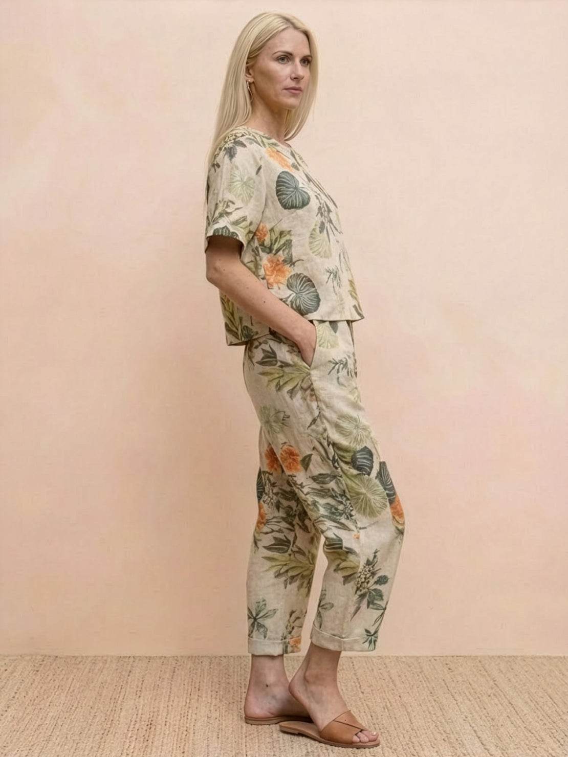 Woman wearing relaxed fit cotton linen set with short-sleeve top and straight-leg pants in monochrome tones