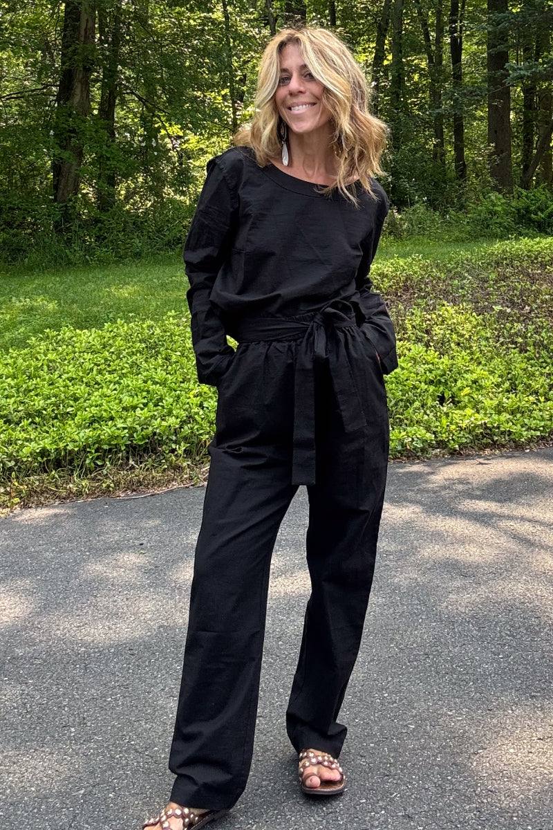 woman wearing black cotton-linen monochrome relaxed longline top and wide-leg pants outdoors