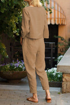 Women wearing cotton-linen monochrome capsule set with relaxed longline top and wide-leg pants in beige outdoors