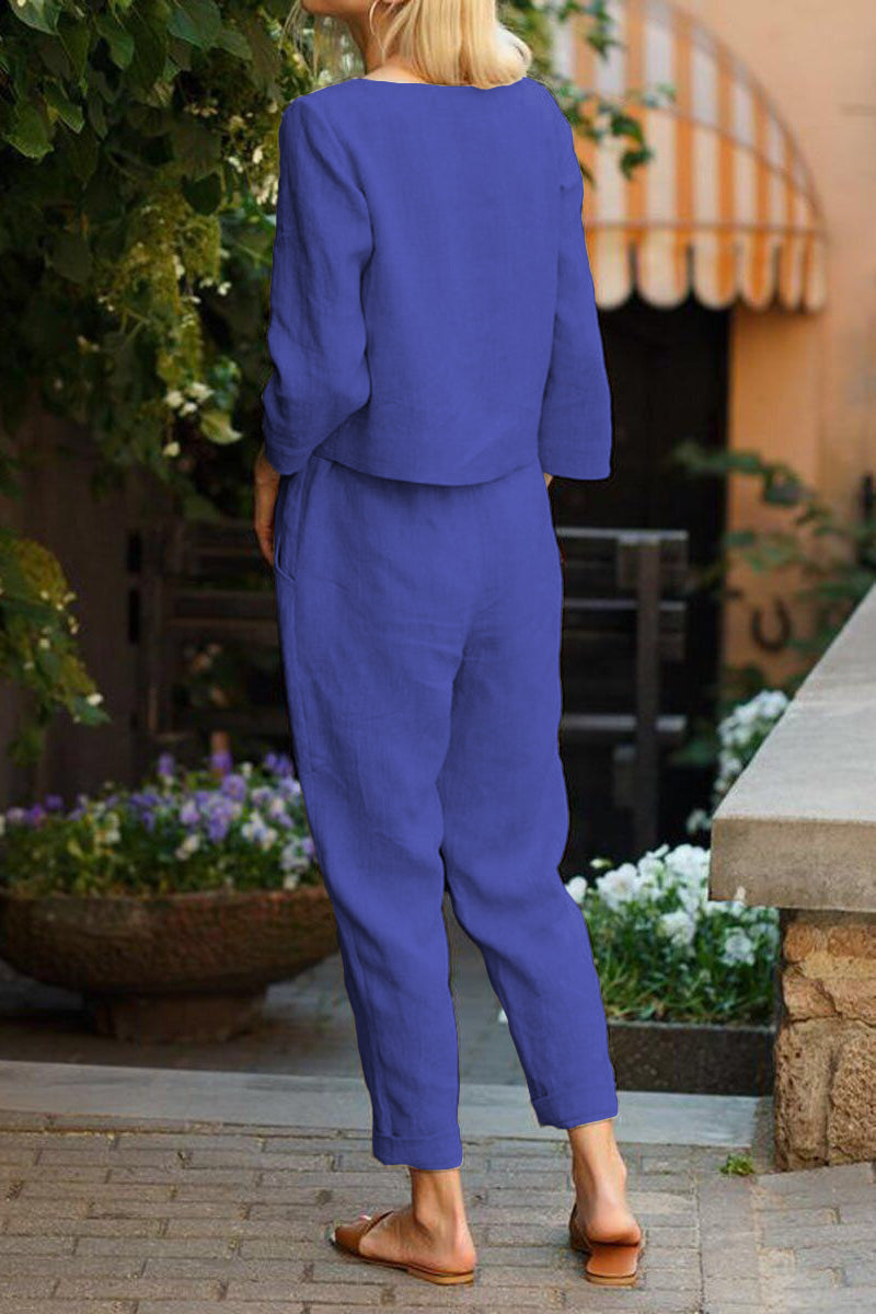 Woman wearing blue cotton-linen monochrome capsule outfit with longline top and wide-leg pants outdoors