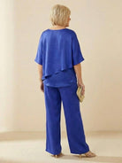 Woman wearing Elegant Layers Two-Piece Set with layered V-neck top and matching pants in light fabric