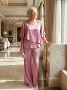 Woman wearing Elegant Layers Two-Piece Set with layered V-neck top and matching pants