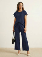 Elegant first class travel two-piece set with wrinkle-resistant viscose-acrylic fabric and pleated wide-leg design