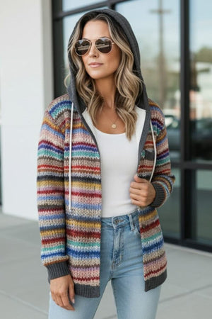 Woman wearing cozy striped knit hooded Highland Plaid Shacket with zipper over white top and jeans outdoors