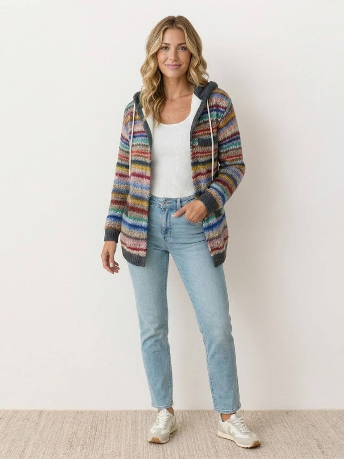 Woman wearing Highland Plaid Shacket layered over jeans with a relaxed hooded fit and button-front closure