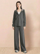 Woman wearing gray Lyocell-blend hooded set with wide-leg pants and hooded top.