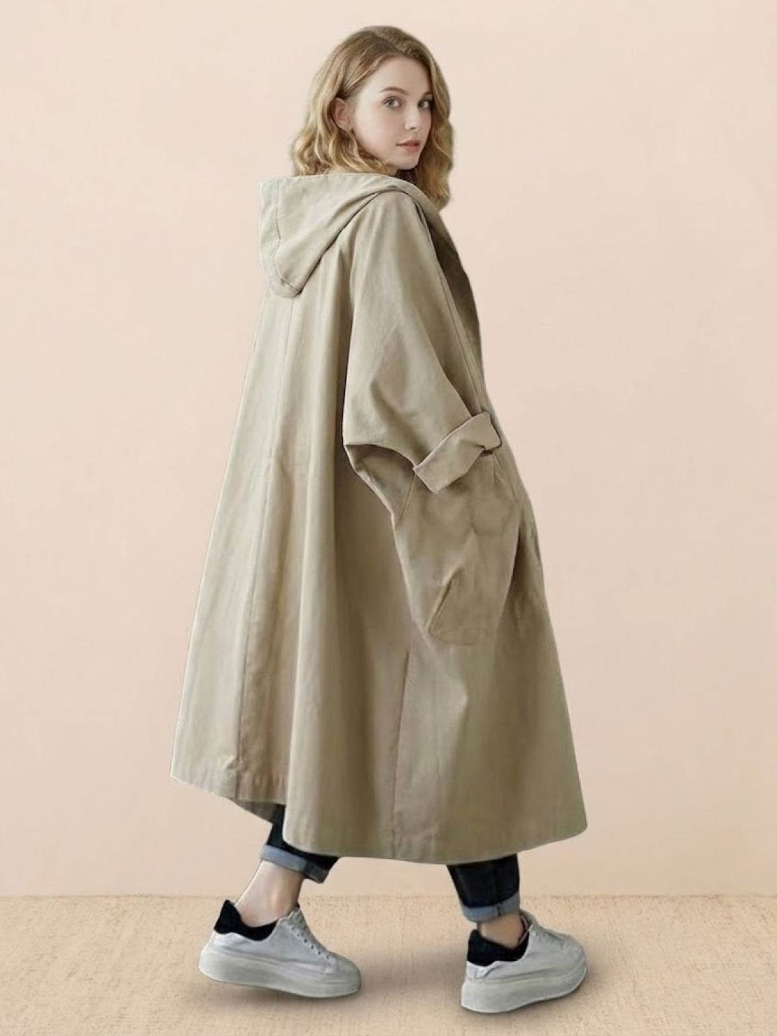 Oversized water-resistant windbreaker jacket with hood and waterproof design worn by woman