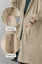 Oversized beige water resistant windbreaker jacket with large pockets and snap-button closure