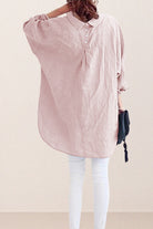 woman wearing oversized linen shirt in sun-washed pink with back button details and relaxed fit