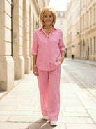 Woman wearing oversized 100% cotton shirt with wide-leg pants co-ord set in neutral color