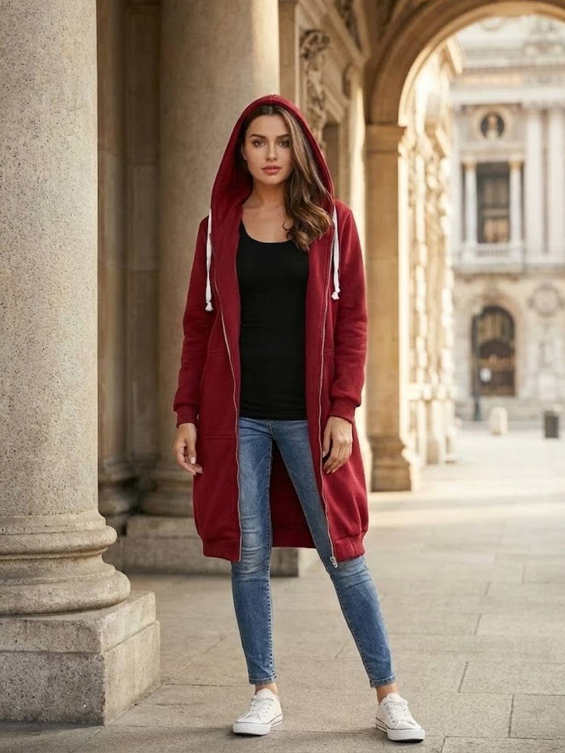 Woman wearing oversized long zip sweatshirt hoodie in red with hood, front pockets, and relaxed fit