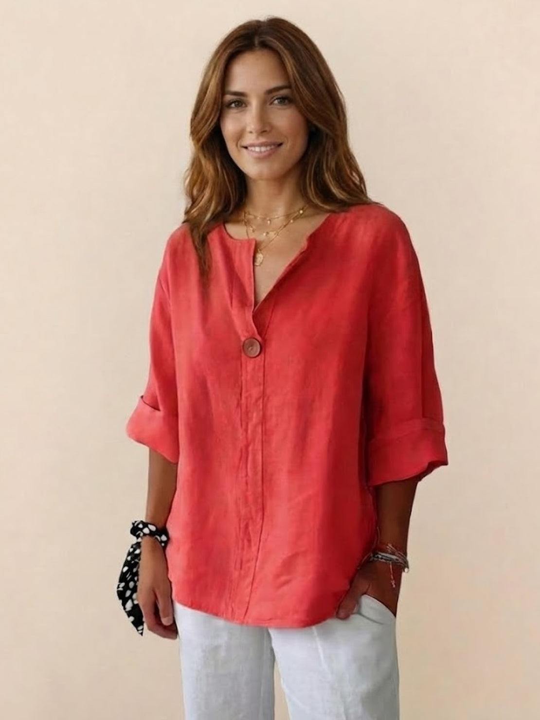 Woman wearing coral pure linen age-defying shirt with button detail and rolled sleeves