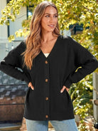 Relaxed fit oversized black button down knitwear cardigan on woman outdoors