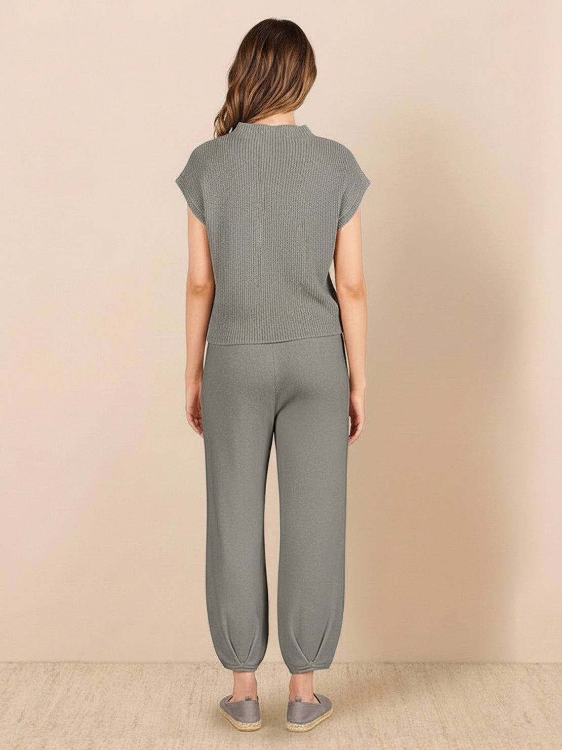 Woman wearing Comfy Couture knit sweater two-piece set in neutral color, relaxed fit with matching pants