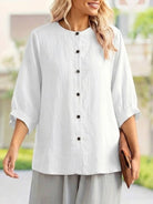 Relaxed loose breathable linen blouse with button-down front and three-quarter sleeves in white.