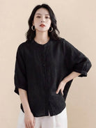 Relaxed loose breathable linen black blouse with buttons and 3/4 sleeves on woman