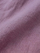 Close-up of relaxed loose breathable linen fabric in soft purple color