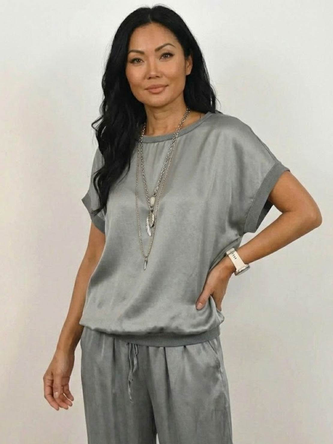 Model wearing Silken Escape Satin Two-Piece Set with wide-leg pants and slim top in elegant satin fabric