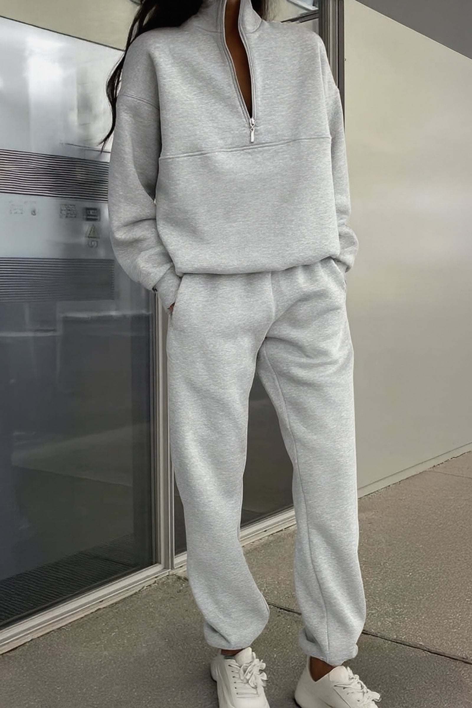 Minimal grey cotton blend tracksuit with zip collar and relaxed fit on model