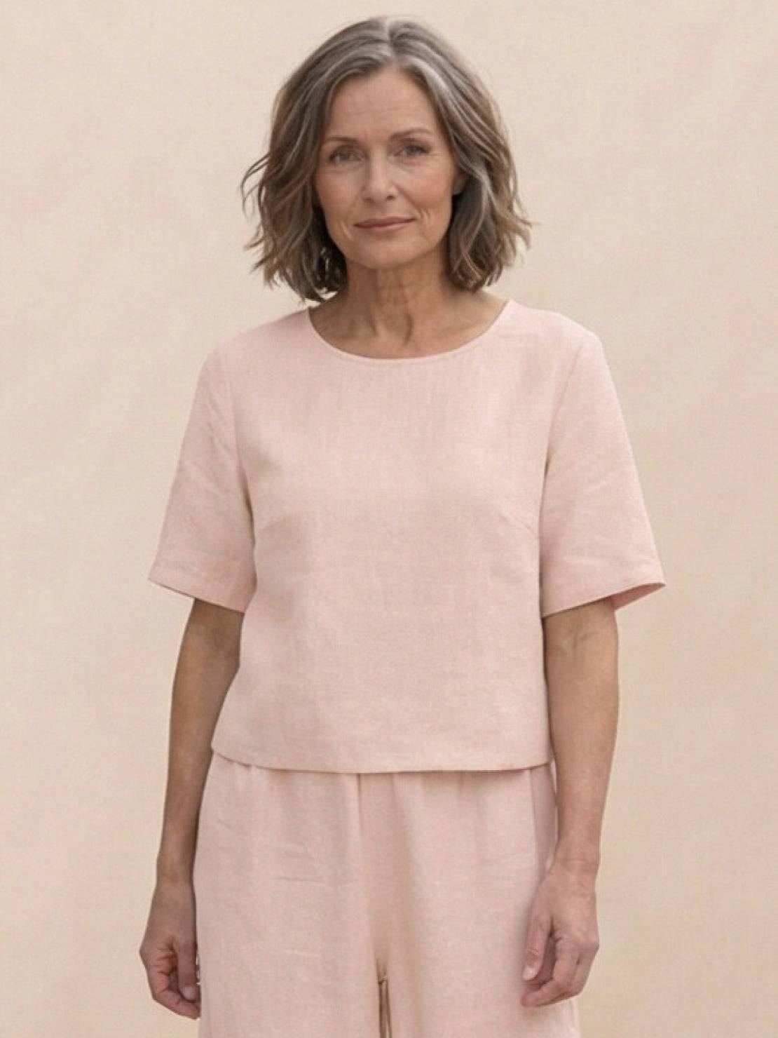 Woman wearing loose fit co-ord set with soft-tailored top and wide-leg bottoms in relaxed style