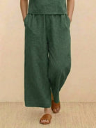 green loose fit wide-leg pants from a co-ord set with elastic waistband and relaxed pockets