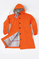 Orange Rain Couture Windbreaker with hood and plaid interior lining, water-resistant oversized jacket designed for style and comfort
