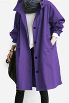 Purple oversized Rain Couture Windbreaker water-resistant jacket with buttons and pockets worn over casual outfit