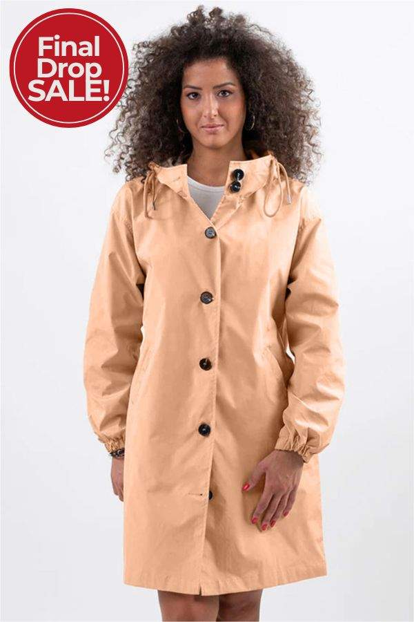 woman wearing beige oversized Rain Couture Windbreaker jacket with hood and button details