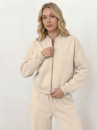The Voyager Zip Set two-piece zip-front sweatshirt and wide-leg joggers in neutral tones for travel and casual style