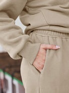 Close-up of beige ultra-soft and comfy co-ord tracksuit set with elastic waistband and side pocket detail