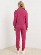 Unisex half-zip pullover and sweatpants set in soft fabric with relaxed fit for casual wear and travel