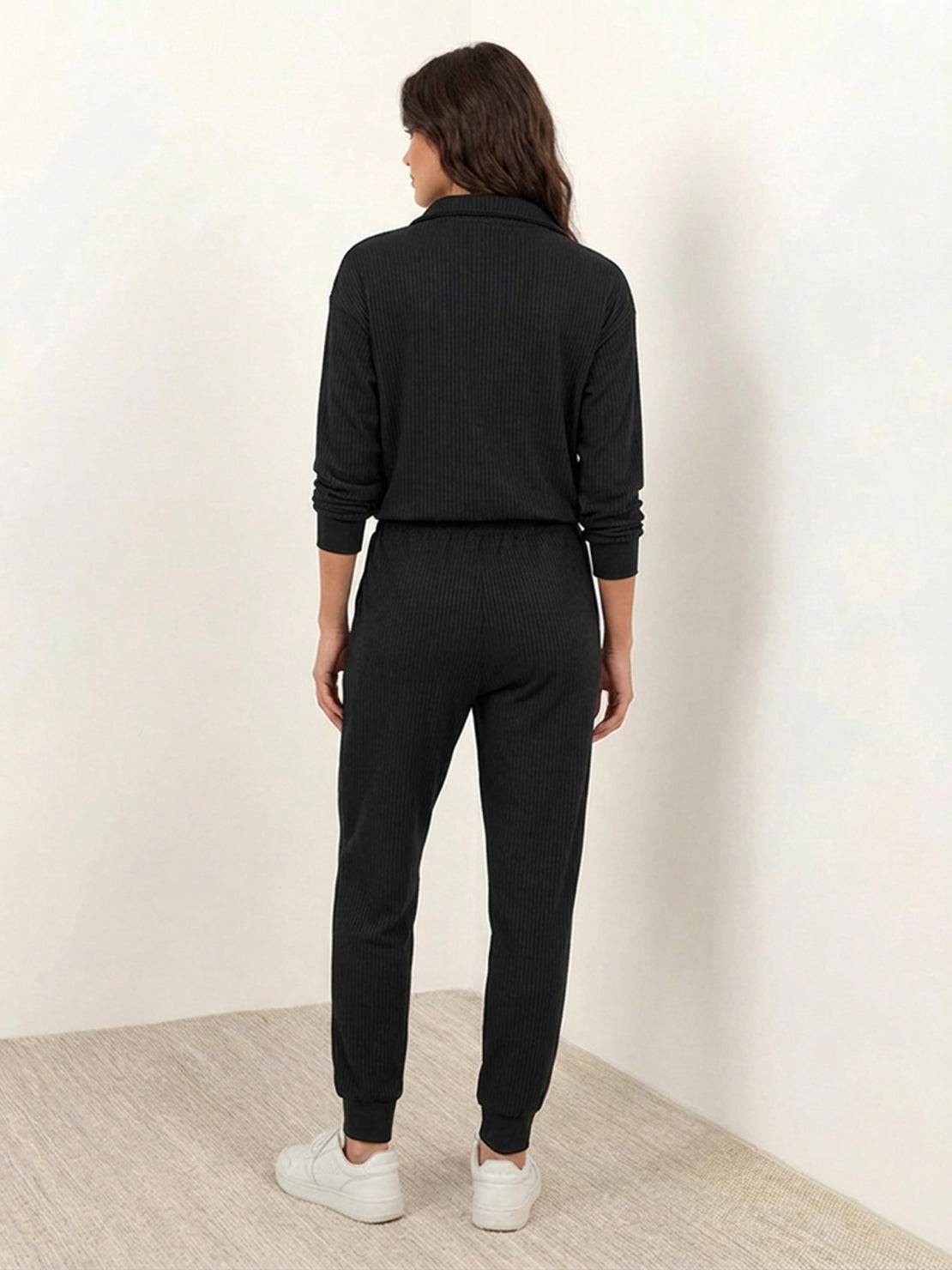 Unisex half-zip pullover and matching sweatpants set in soft, flexible fabric for casual comfort and travel