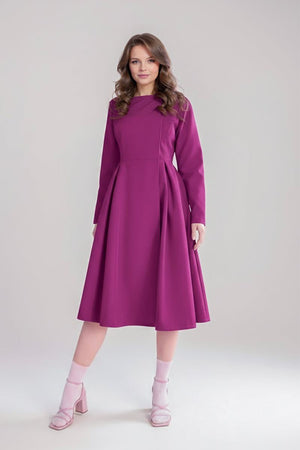 Woman wearing a purple water-repellent rain A-line dress coat with long sleeves and fitted waist belt