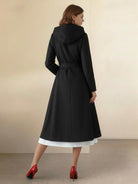 Woman wearing water-repellent rain A-line hooded raincoat with belt and insulated lining